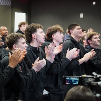 The Miami men’s basketball team reacts to seeing their name called during the NCAA Tournament Selection Show on Sunday. CHRIS VOGT / CONTRIBUTED