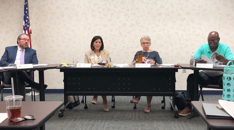 Preschool Promise board members (from left) PJ Brafford, Debbie Feldman, Jane McGee-Rafal and Clay Dixon listen to a presentation at their board meeting June 26, 2019. JEREMY P. KELLEY / STAFF