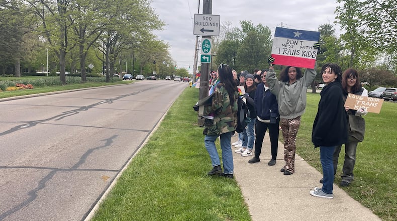 The selection of two gender fluid seniors for Fairmont High School’s prom king and queen has sparked debate in Kettering City Schools. Rosita Green (foreground in blue coat) and Dai'sean Conley (holding red, white and blue sign) were picked as king and queen, respectively, by Fairmont students. NICK BLIZZARD/STAFF