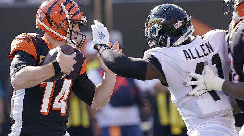 CINCINNATI, OHIO - OCTOBER 20: Andy Dalton (14) of the Cincinnati Bengals is sacked by Josh Allen (41) of the Jacksonville Jaguars during the NFL football game at Paul Brown Stadium on October 20, 2019 in Cincinnati, Ohio. (Photo by Bryan Woolston/Getty Images)