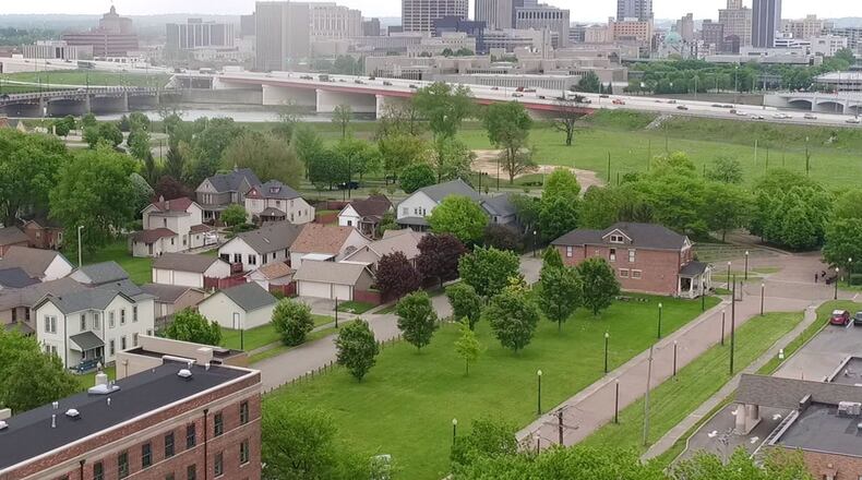 Charles Simms Development is looking at constructing new attached, two-story homes that have about 1,300 square feet of space in the Wright Dunbar neighborhood. The housing, possibly called the Cottages at Wright Dunbar, remains in the planning phase, but the homes could sell for between $150,000 and $200,000. The first 10 or so homes could be built on vacant land near Oak and Ivy Park, shown in the foreground of this aerial view looking east. TY GREENLEES / STAFF