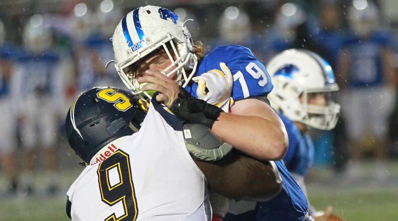 Springboro offensive lineman Evan Brown (79) takes on Bryce Walker of Springfield. Top-ranked Springfield (D-I) defeated No. 2 Springboro 23-0 in a Week 7 high school football game on Friday, Oct. 11, 2019. MARC PENDLETON / STAFF
