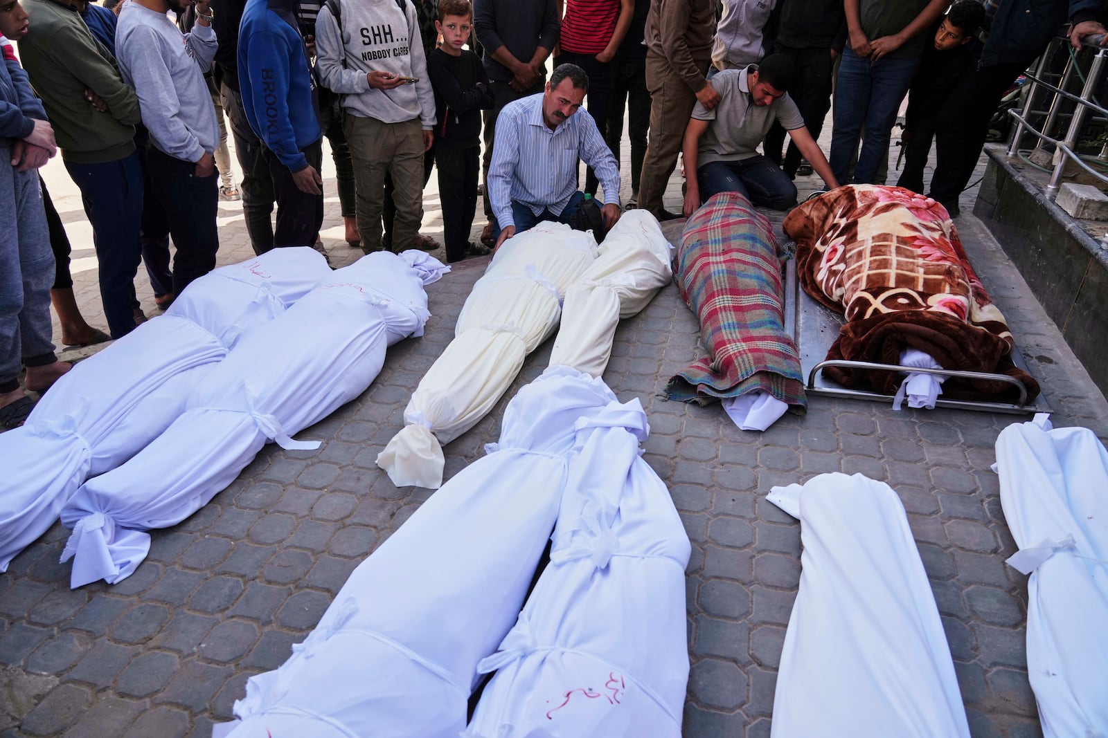 Palestinians mourn over the bodies of their relatives who were killed in an Israeli airstrike, as they brought to Shifa Hospital in Gaza City, on Saturday, April 26, 2025. (AP Photo/Jehad Alshrafi)