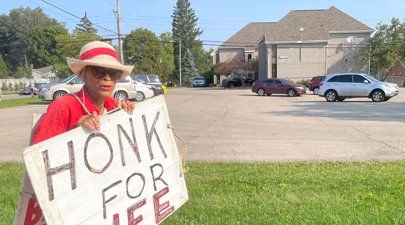 Vivian Skovgard holds up a "Honk for Life" sign outside Women's Med Center Friday morning. The clinic saw a surge of patients following a ruling from a Hamilton County judge temporarily pausing Ohio's Heartbeat law./ STAFF PARKER PERRy