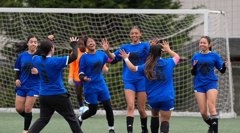 Aubrey Decraig, third from right, celebrates with teammates after scoring a goal during a soccer tournament for immigrant and refugee girls on Sunday, March 29, 2026, in Portland, Ore. (AP Photo/Jenny Kane)
