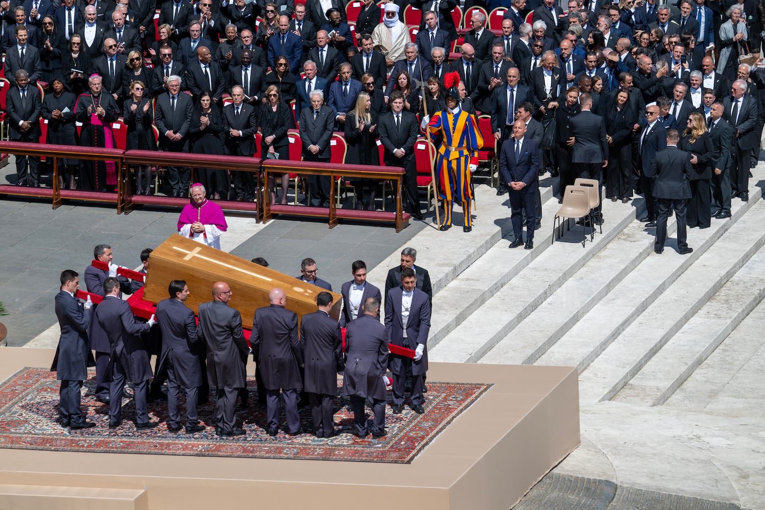The gentlemen of the Vatican tilt the coffin of Pope Francis towards the crowds at his funeral service, at St. PeterÕs Square on Saturday, April 26, 2025. (James Hill/The New York Times). 