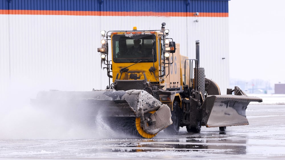 A snow front broom clears the runway at Dayton International Airport on Tuesday, Dec. 2, 2025. BRYANT BILLING/STAFF
