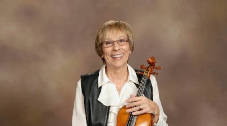 Melinda Hofstetter plays the violin over the phone for members of her church who can't attend services.