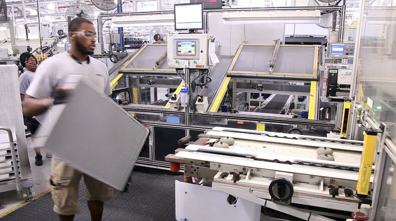 Mahle Behr worker Jeff Frierson moves a radiator to a crimping machine in this file photograph. TY GREENLEES / STAFF