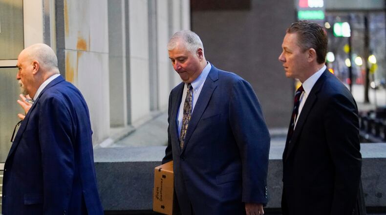 Former Ohio House Speaker Larry Householder, center, walks into Potter Stewart U.S. Courthouse with his attorneys, Mark Marein, left, and Steven Bradley, right, before jury selection in his federal trial, Friday, Jan. 20, 2023, in Cincinnati. Householder and former Ohio Republican Party chair Matt Borges are charged with racketeering in an alleged $60 million scheme to pass state legislation to secure a $1 billion bailout for two nuclear power plants owned by Akron, Ohio-based FirstEnergy. Householder and Borges have both pleaded not guilty. (AP Photo/Joshua A. Bickel)