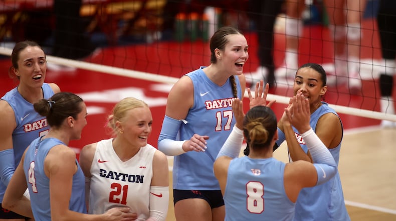Dayton celebrates a victory against Davidson on Friday, Nov. 8, 2024, at the Frericks Center in Dayton. David Jablonski/Staff