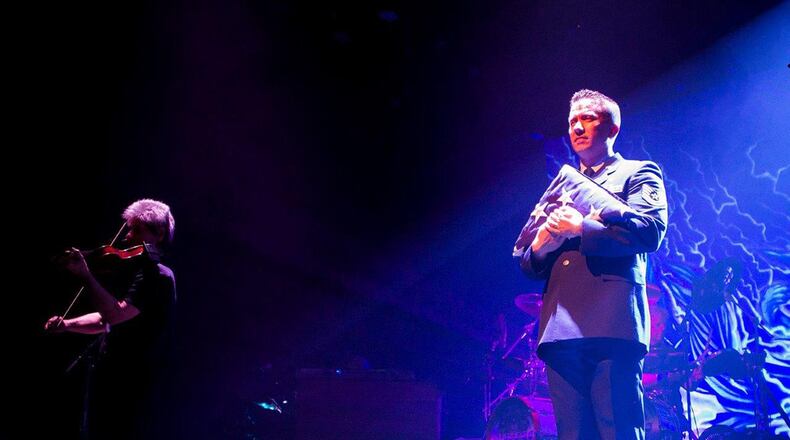 Members of the classic rock group Kansas perform their tribute song “Section 60” during a concert at the Victoria Theatre, Dayton, March 21. Tech. Sgt. Anthony Ritchie assisted during the performance by carrying the American flag out onto the stage during the performance. (U.S. Air Force photos/Jim Varhegyi)