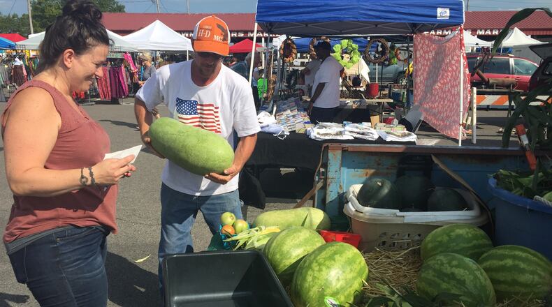 Chef Sara Bradley shops for melons at the Paducah farmers market that takes place downtown on Saturdays. (Lori Rackl/Chicago Tribune/TNS)