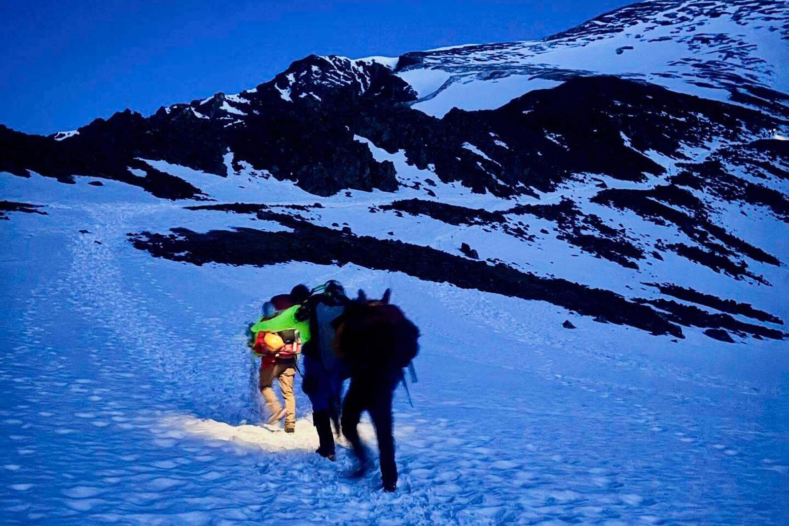 In this image provided by the Alpine Rescue Team, Alpine Rescue Team members take part in helping get two men struck by lightning off Torreys Peak in Colorado, Thursday, June 12, 2025. (Jake Smith/Alpine Rescue Team via AP)