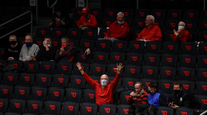 Dayton fans celebrate after a basket against Duquesne on Wednesday, Jan. 13, 2021, at UD Arena. David Jablonski/Staff