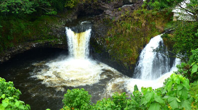 The twin plunges of Ka’imu’kanaka Falls are seen from a private viewing deck during the Hawaii Forest & Trail waterfall tour. (Brian J. Cantwell / Seattle Times/TNS)