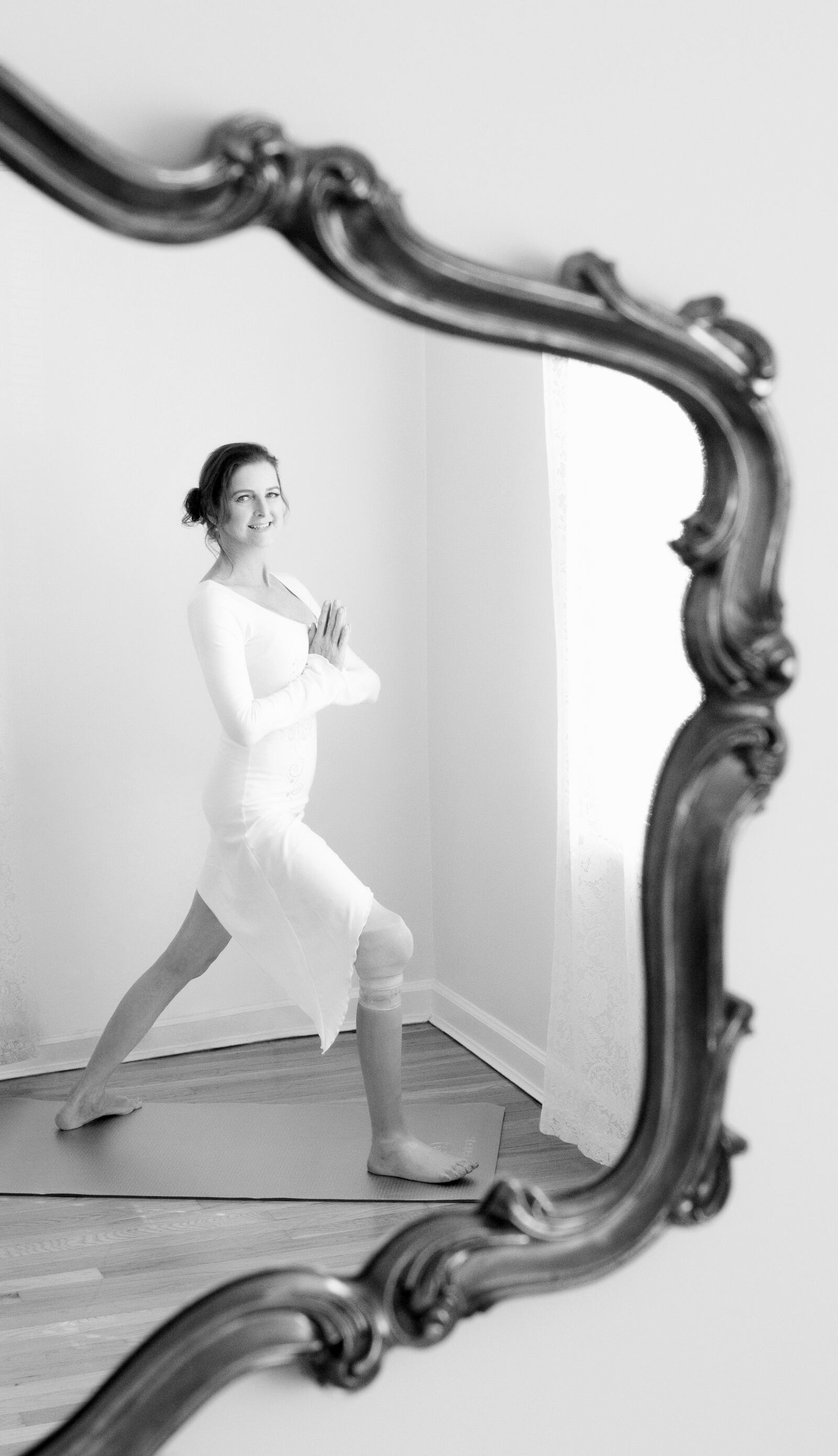 Marsha Therese Danzig, shown in the standing warrior pose. The Dayton yoga instructor and author is an amputee who has battled cancer and had a kidney transplant. AMANDA BARBOSA STUDIOS