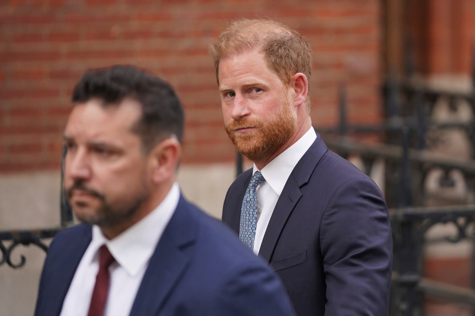 Britain's Prince Harry looks at the media as he leaves the Royal Courts of Justice in London, Tuesday, April 8, 2025. (AP Photo/Alberto Pezzali)