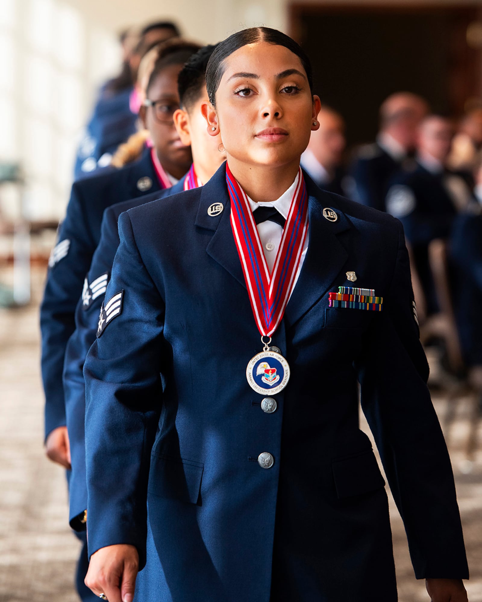 Senior Airman Gwendolyn Sounders, 88th Surgical Operations Squadron leads her class into their Airman Leadership School graduation on June 16 in the Wright-Patterson Club and Banquet Center. ALS is required for staff sergeant selects and open to eligible civilians as Airmen learn more about leadership and Air Force culture. U.S. AIR FORCE PHOTO/R.J. ORIEZ