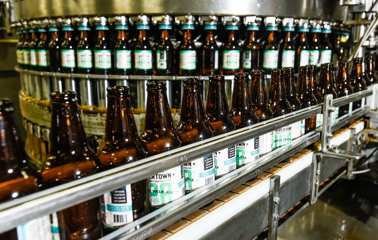 Bottles of beer are filled at Rivertown Brewery & Barrel House Wednesday, June 14 in Monroe. NICK GRAHAM/STAFF