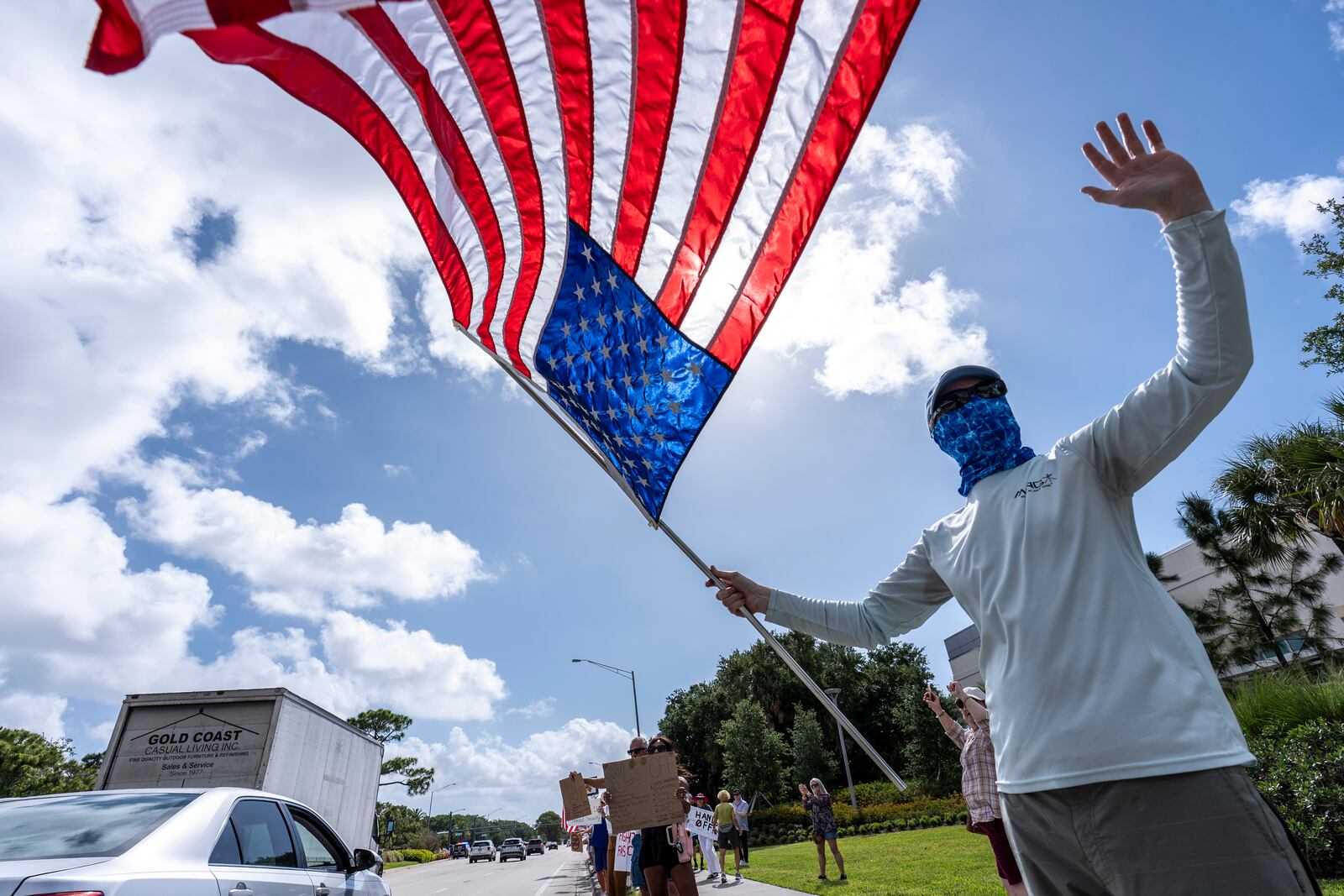 Activists protest President Donald Trump, who was a few miles away at his Trump National Golf Club, during a "Hands Off!" demonstration Saturday, April 5, 2025, in Palm Beach Gardens, Fla. (AP Photo/Alex Brandon)