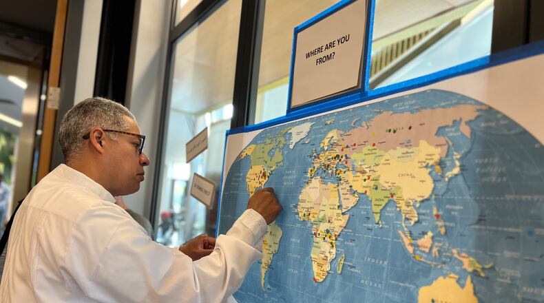 Attendees to Welcome Dayton's World Refugee Day celebration on Saturday each pinned their home land on a map. AIMEE HANCOCK/STAFF