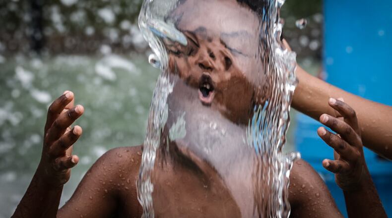 Kids and adults enjoyed the splash pad at Island MetroPark Tuesday June 18, 2024. This week temperatures are in the mid-90s with heat index, or "feels like" temperatures around 100 degrees. JIM NOELKER/STAFF