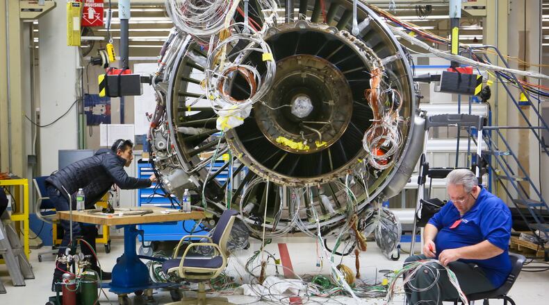 GE Aviation said Thursday Singapore Airlines has announced an order valued at $2 billion to the company. In this December 2014 photo, engineers work on a LEAP commercial jet test engine at GE Aviation in Evendale. GREG LYNCH / STAFF