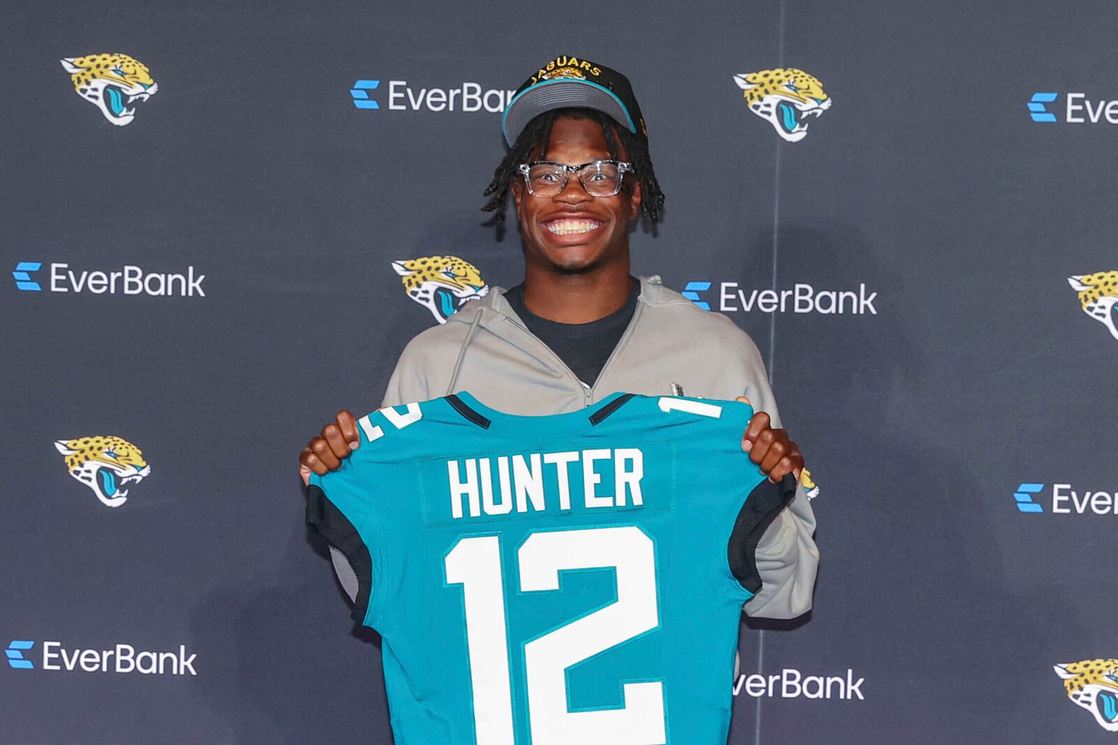 Two-way player Travis Hunter, the Jacksonville Jaguars first round draft pick, second overall, pose with a jersey during an NFL football press conference, Friday, April 25, 2025, in Jacksonville, Fla. (AP Photo/Gary McCullough)