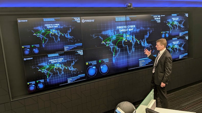 FILE - The CEO of FireEye Kevin Mandia gives a tour of the cybersecurity company's unused office space in Reston, Va., March 9, 2021. (AP Photo/Nathan Ellgren, file)