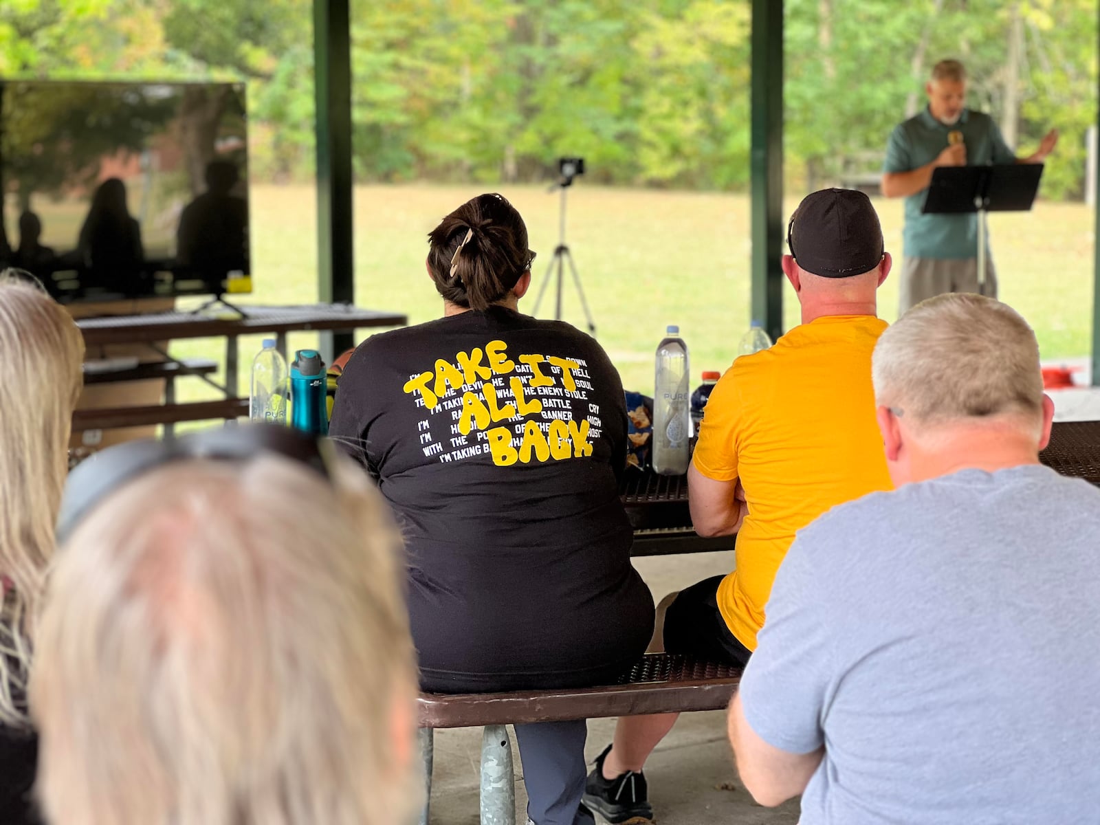 Attendees to a memorial honoring Charlie Kirk listen as organizer Sean Ryan speaks in Kettering Sunday. AIMEE HANCOCK/STAFF