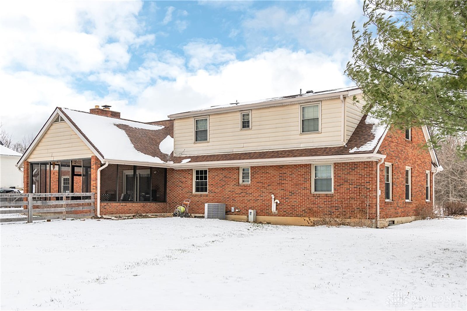 The back of the house features a screened in porch and partially fenced yard. CONTRIBUTED