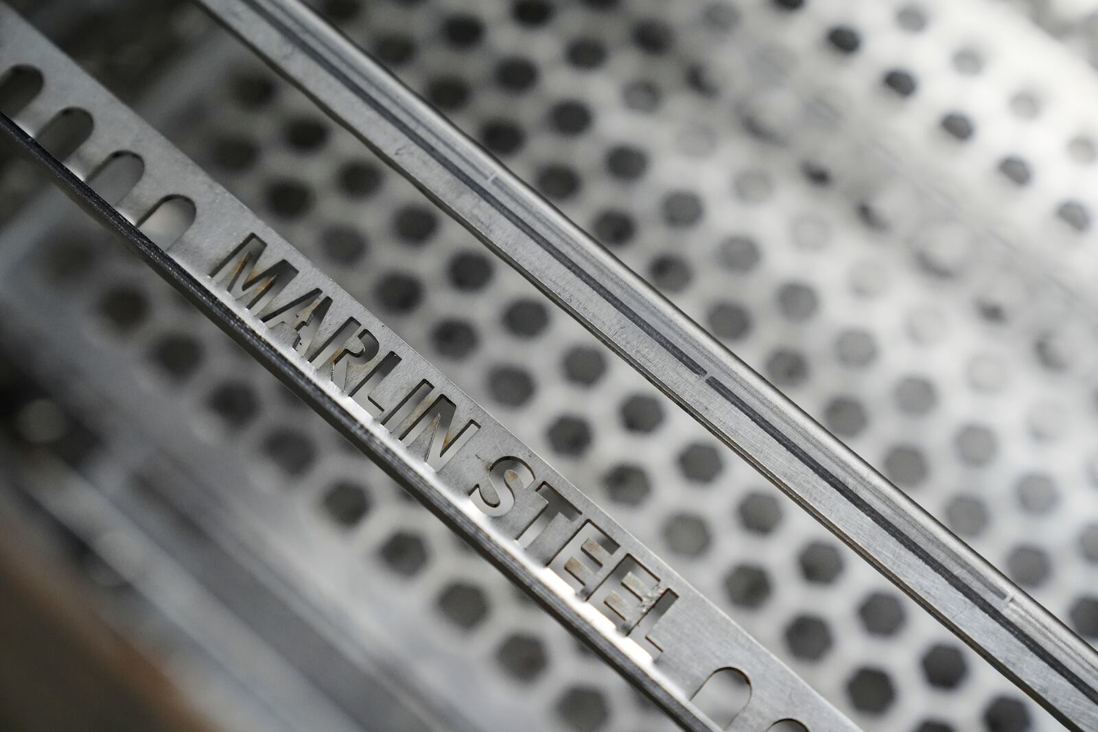 Name-plated steel pieces are seen at the Marlin Steel Wire manufacturing plant in Baltimore, Thursday, April 17, 2025. (AP Photo/Stephanie Scarbrough)