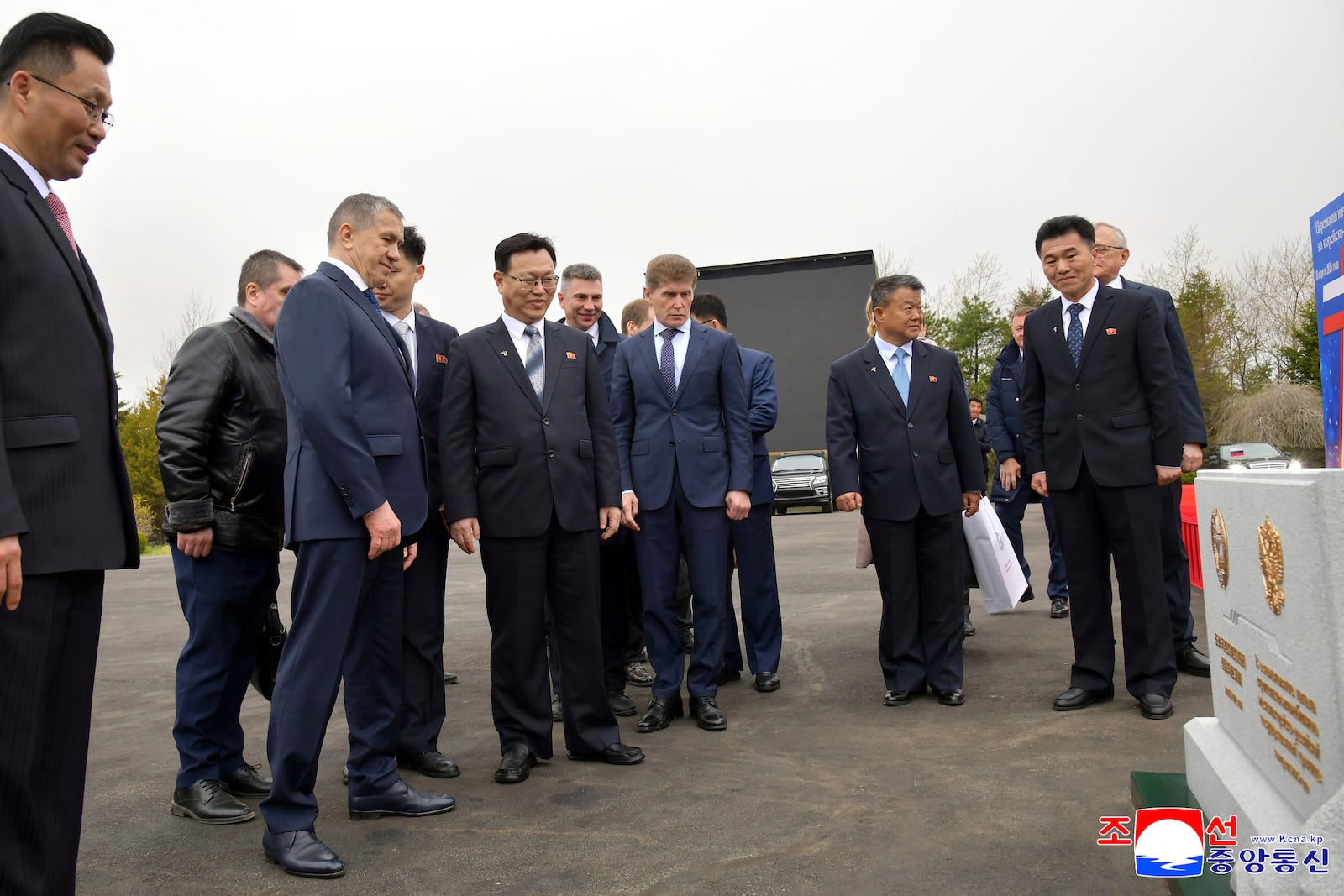 In this photo provided by the North Korean government, officials from North Korean and Russia stand in front of a monument to mark a ground-breaking ceremony for the construction of a bridge between the two countries, in Rason Municipality, North Kora Wednesday, April 30, 2025. Persons are not identified. Independent journalists were not given access to cover the event depicted in this image distributed by the North Korean government. The content of this image is as provided and cannot be independently verified. Korean language watermark on image as provided by source reads: "KCNA" which is the abbreviation for Korean Central News Agency. (Korean Central News Agency/Korea News Service via AP)