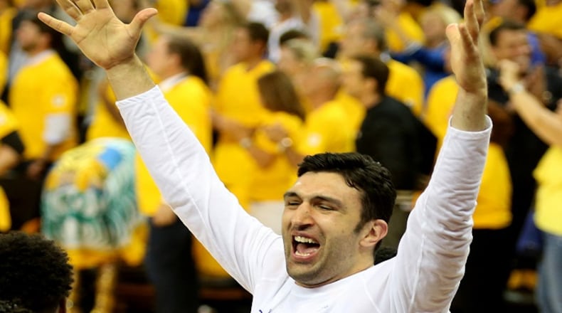 The Golden State Warriors' Zaza Pachulia and Ian Clark celebrate after defeating the Cleveland Cavaliers in Game 5 of the NBA Finals at Oracle Arena in Oakland, Calif., on June 12, 2017. (Ray Chavez/Bay Area News Group/TNS)