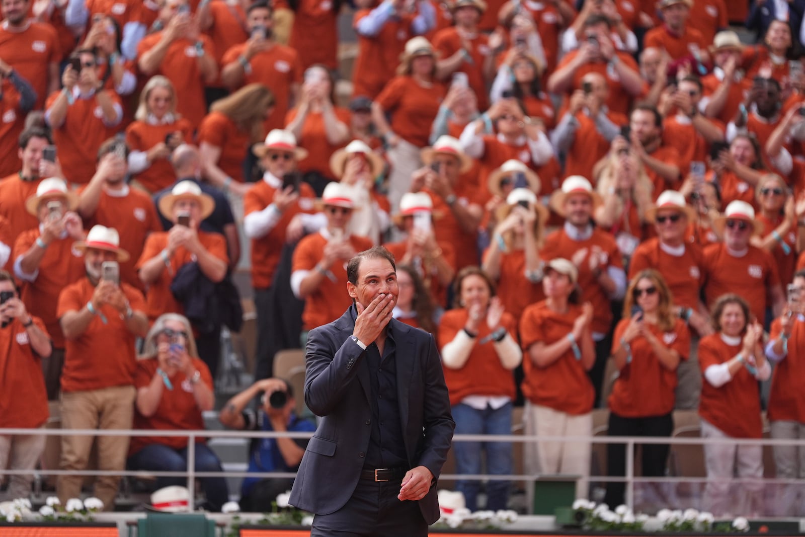 Rafa Nadal is cheered by the crowd during a farewell ceremony at center court Philippe-Chatrier, at the Roland-Garros stadium, in Paris, Sunday May 25, 2025. (AP Photo/Lindsey Wasson)