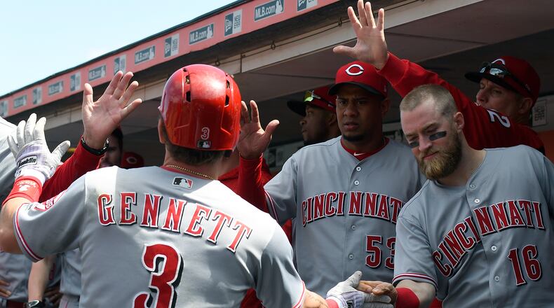 SAN FRANCISCO, CA - MAY 16: Scooter Gennett #3 of the Cincinnati Reds is congratulated by teammates Tucker Barnhart #16 and Wandy Peralta #53 after Gennett hit a solo home run against the San Francisco Giants in the top of the seventh inning at AT&T Park on May 16, 2018 in San Francisco, California. (Photo by Thearon W. Henderson/Getty Images)