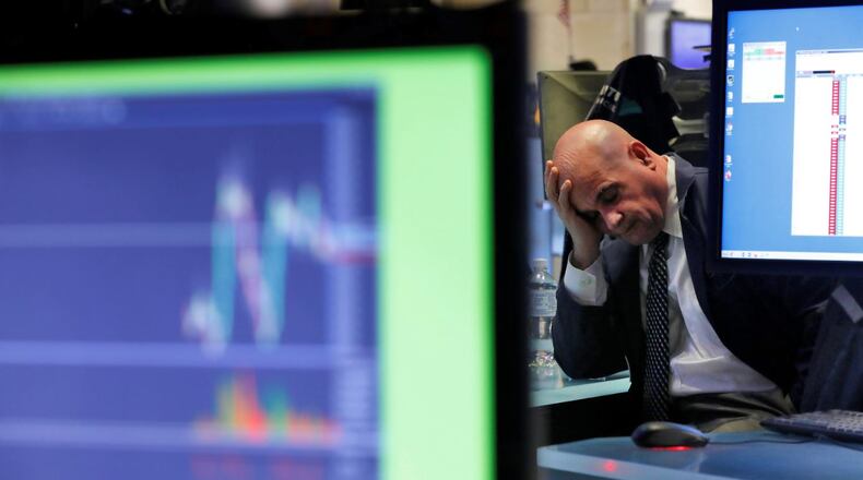 A specialist rests his head in his hand as he works on the floor of the New York Stock Exchange, Tuesday, Feb. 25, 2020. U.S. stocks fell in midday trading Tuesday, a day after the market’s biggest drop in two years, as traders worry that the spreading coronavirus will threaten global economic growth. (AP Photo/Richard Drew)