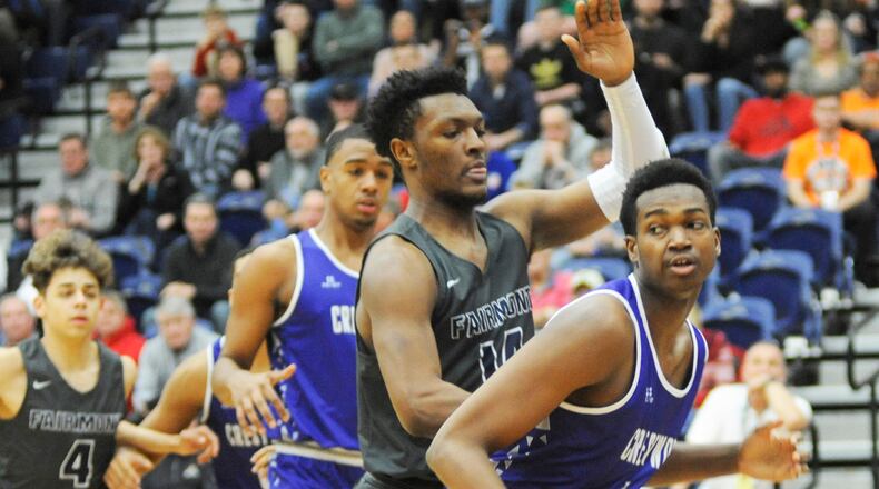 Fairmont’s DaShawn Brown (middle) gets defensive with Crestwood’s Jo Smith (with ball). MARC PENDLETON / STAFF