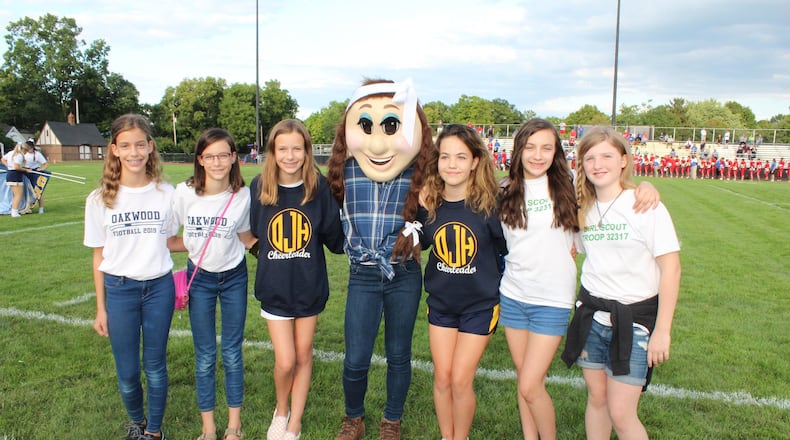Brigid Newman, Clare Newman, Anna Newman , Principal Paul Waller, Ashlyn Steinbrink, Natalia Rubin-Alvarez and Lena Gaskin pose with “Jill,” the new mascot created by members of Oakwood Girl Scout Troup 32317 in order to bring a female mascot to represent the girls sports teams at Oakwood schools.