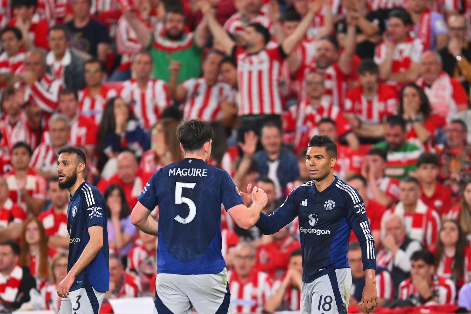 Manchester United's Casemiro, right, celebrates after scoring his side's opening goal during the Europa League semifinal first leg soccer match between Athletic Bilbao and Manchester United at the San Mames stadium in Bilbao, Spain, Thursday, May 1, 2025. (AP Photo/Miguel Oses)