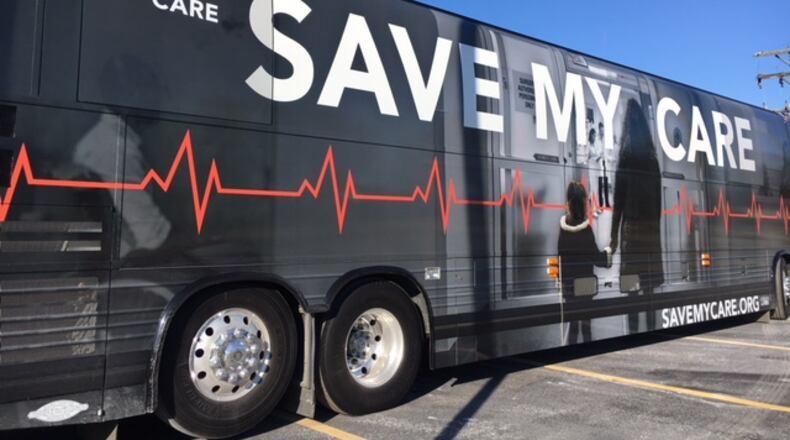 A group touring the nation by bus, urging the preservatio of the Affordable Care Act, stopped at a West Dayton health clinic Monday. THOMAS GNAU/STAFF