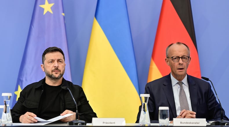 Ukrainian President Volodymyr Zelenskyy, left, and German Chancellor Friedrich Merz attend a video meeting of European leaders with US President Donald Trump on the Ukraine war in Berlin, Germany, Wednesday, Aug. 13, 2025, ahead of the summit between the US and Russian leaders. (John MacDougall/Pool Photo via AP)