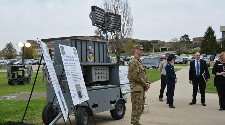 The Air Force hybrid light cart is demonstrated by Senior Master Sgt. Marcus Haralson of the Air Force Materiel Command to senior leaders from across the Air Force at Wright-Patterson Air Force Base April 17. The demo was part of an Air Force Research Laboratory Tech Expo for the Basing and Logistics Board. (U.S. Air Force photo/Karen Schlesinger)