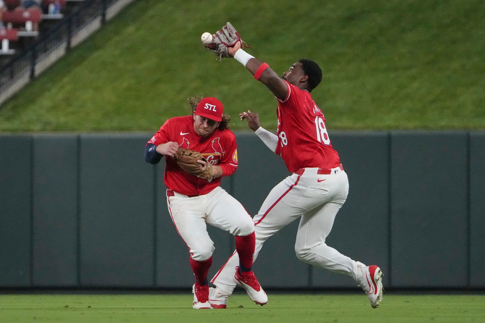 St. Louis Cardinals second baseman Brendan Donovan, left, nearly collides with right fielder Jordan Walker as Walker catches a fly ball by Cincinnati Reds' Connor Joe for an out during the eighth inning of a baseball game Friday, June 20, 2025, in St. Louis. (AP Photo/Jeff Roberson)