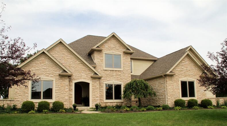 The 4-bedroom home has about 3,430 square feet of living space with a finished lower level that has walk-up access to the 3-car garage. CONTRIBUTED PHOTOS BY KATHY TYLER