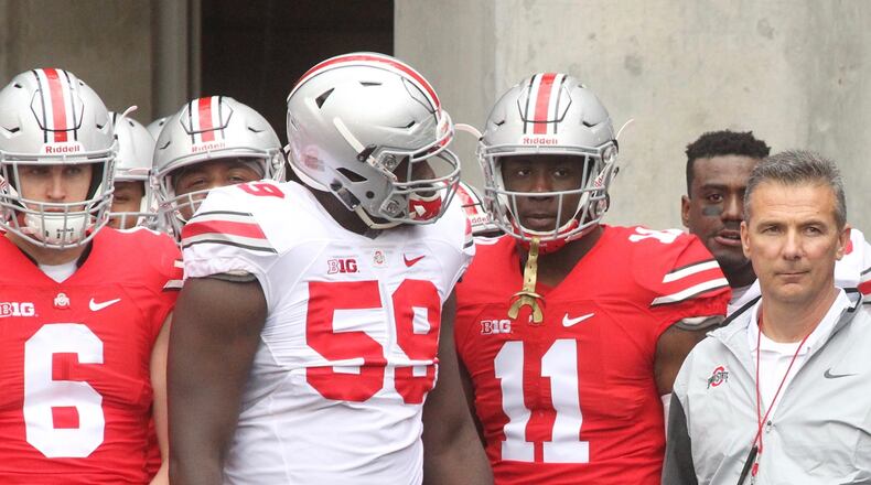 Ohio State’s Sam Hubbard, Tyquan Lewis, Jalyn Holmes and Urban Meyer wait to take the field before the spring game on Saturday, April 15, 2017, at Ohio Stadium in Columbus. David Jablonski/Staff
