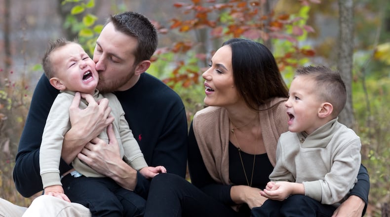 Sean Finn with wife Adriana Bates and sons Sawyer, left, and Sebastian, right. The couple also have a 1-year-old son, Spencer.