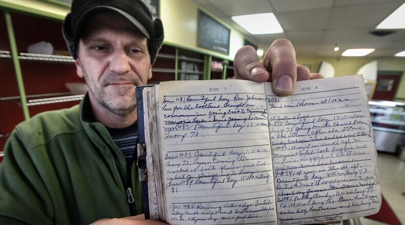 Matt Tepper, the Old North Dayton Neighborhood Association president, shows a diary that landed in Linda Porter’s yard during the Memorial Day tornadoes. Porter sought Tepper’s assistance to find the diary’s writer or current owner. CHRIS STEWART / STAFF