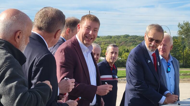 Resonant Sciences Micah North (center) alongside state and local elected officials, sign a beam that will be placed inside the company's latest facility along Research Boulevard, October 2, 2025. LONDON BISHOP/STAFF